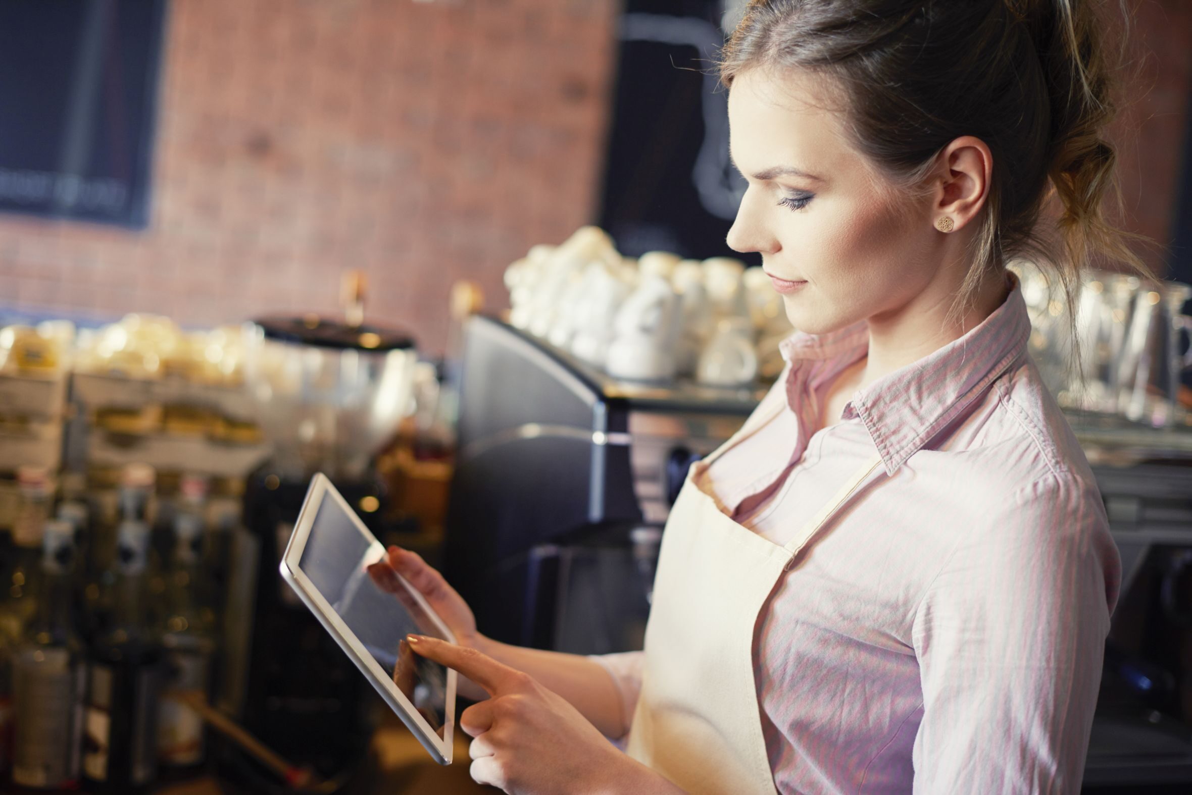 Side view of waitress with digital tablet