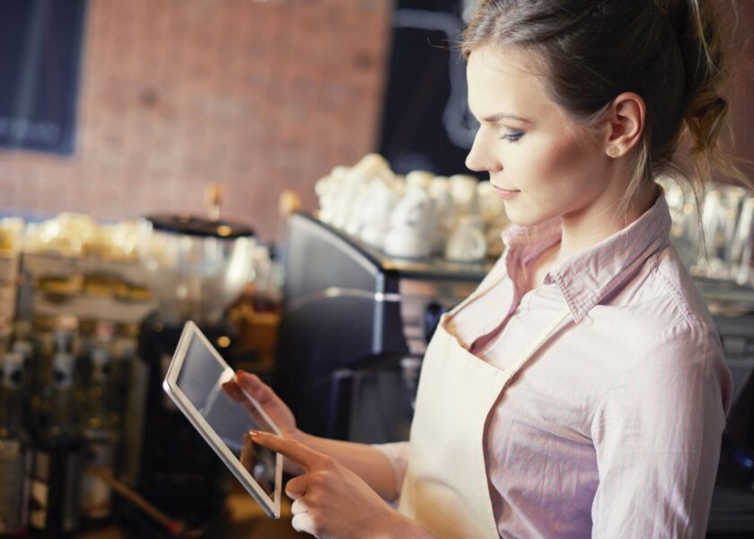 Side view of waitress with digital tablet